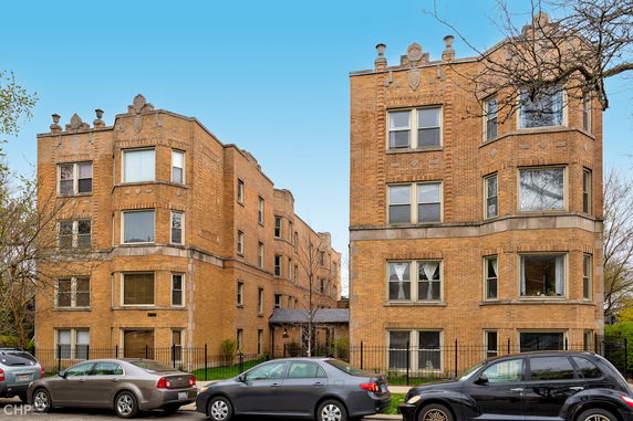 Front view of two adjacent brick apartment buildings.