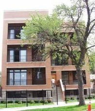 Front view of a multi-story brick apartment building