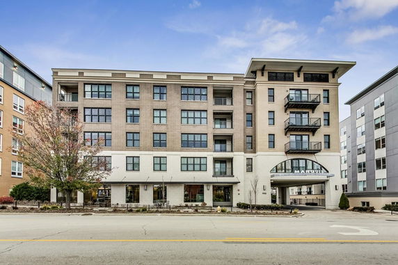 Front view of a multi-story residential building with a contemporary design.