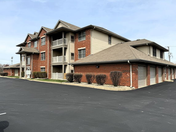 Front view of a multi-story residential building with attached garages.