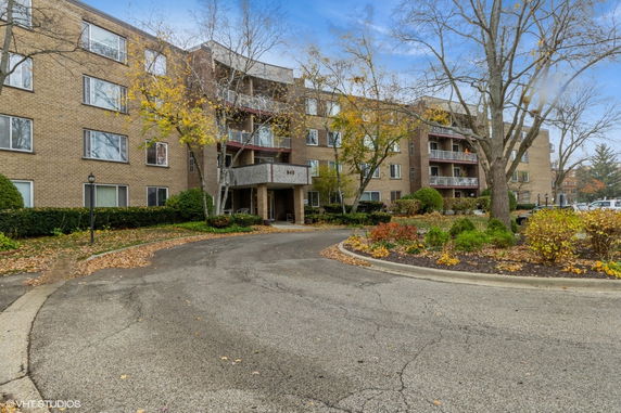 Front view of a multi-story apartment building with balconies.