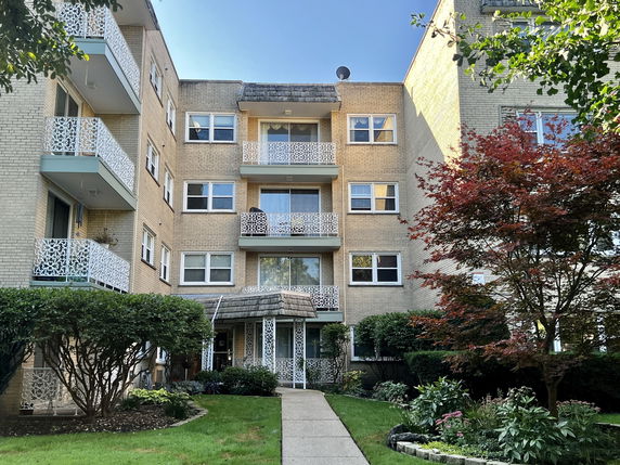 Front view of a multi-story residential building with balconies.