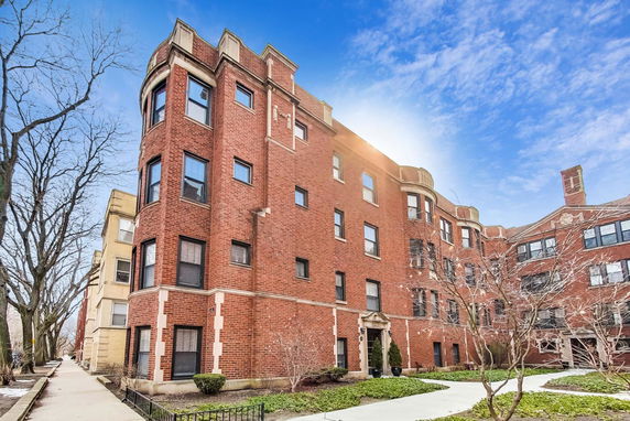 Front view of a multi-story brick apartment building.