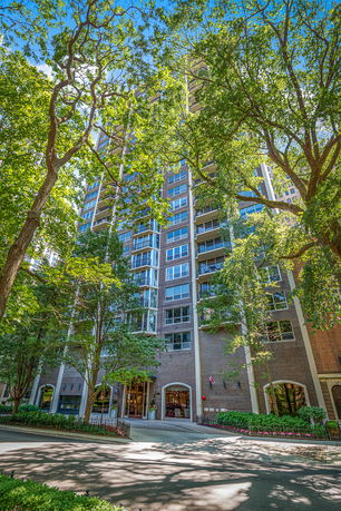 Front view of a multi-story apartment building with balconies.