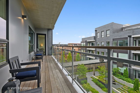 View from a balcony overlooking neighboring apartment buildings.
