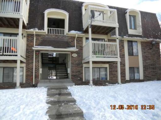 Front view of a multi-story apartment building with balconies.