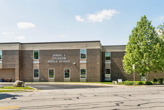 Front view of a middle school building with a brick facade and multiple windows.