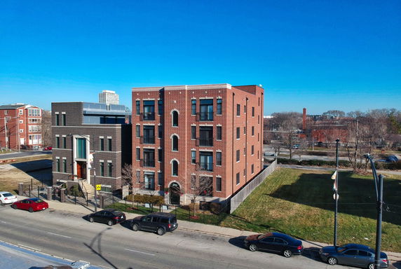 Front view of a multi-story brick building with a modern entrance.