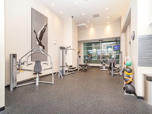 Indoor gym area with exercise equipment and fitness balls.