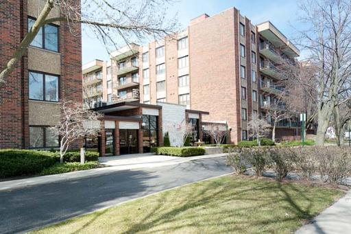 Front view of a multi-story brick apartment building.