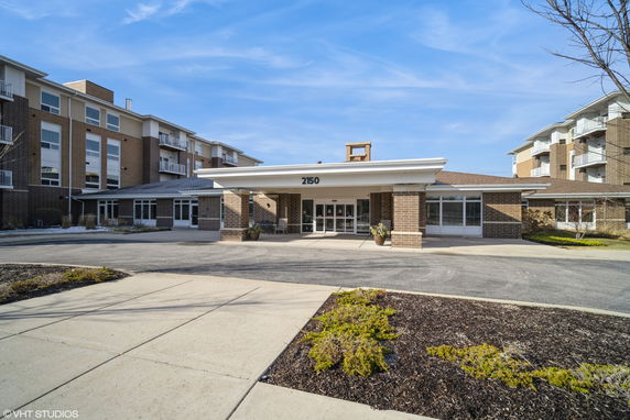 Front view of a multi-story building with a covered entrance.