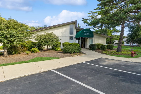 Front view of a building with a green canopy entrance.