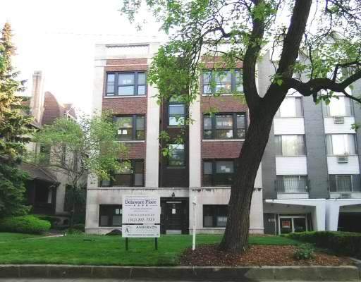 Front view of a multi-story building with brick and concrete facade.