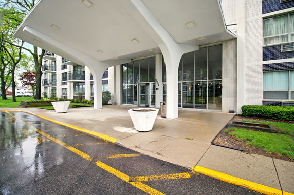 Front view of a multi-story building with large entrance canopy.