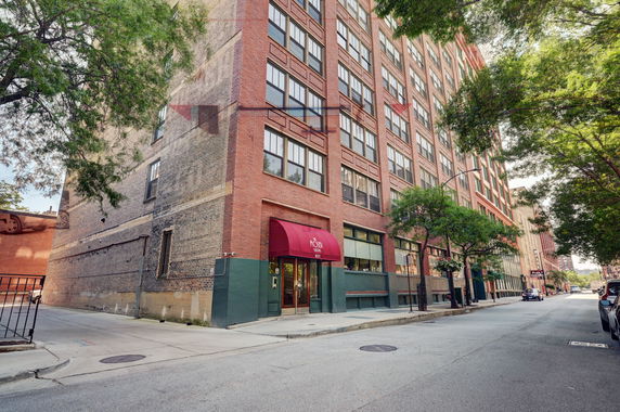 Front view of a multi-story brick building with entrance.