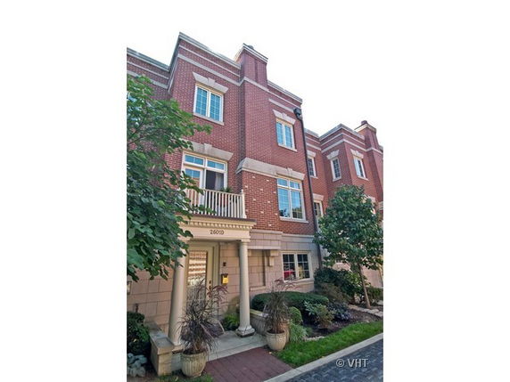 Front view of a multi-story brick building with a small entrance area.