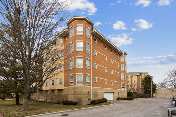 Front view of a multi-story brick building with numerous windows.