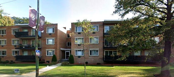 Front view of a three-story brick apartment building.