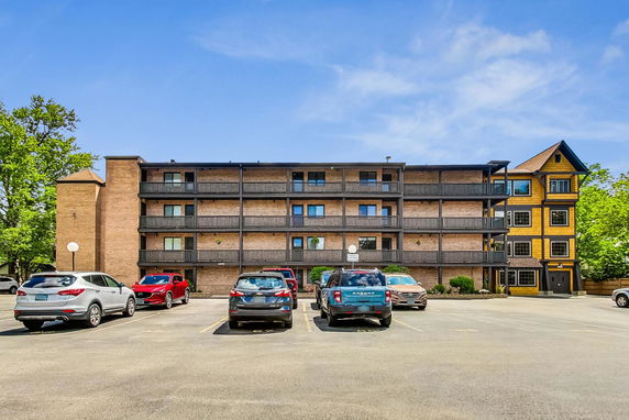 Front view of a multi-story apartment building with balconies.