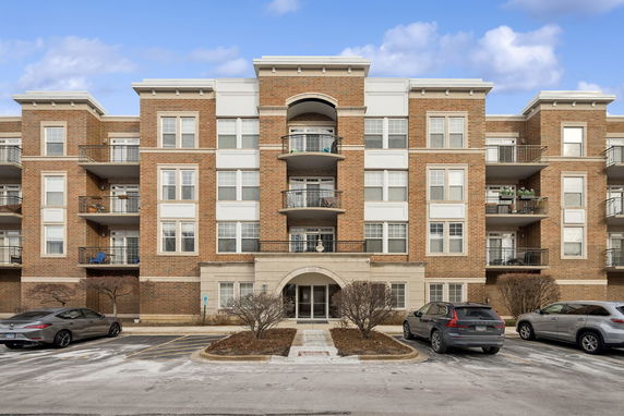 Front view of a multi-story apartment building with balconies.