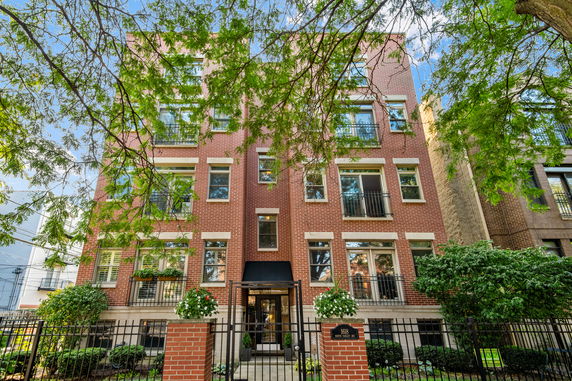 Front view of a multi-story brick apartment building.