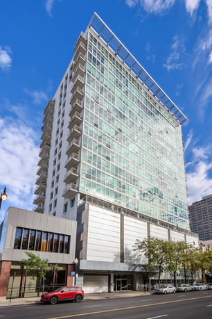 Front view of a multi-story building with a glass facade.