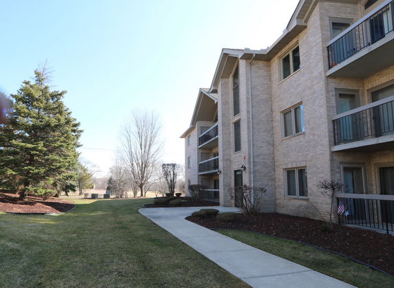 Front view of a multi-story apartment building with balconies.