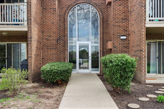 Entrance view of a brick building with an arched doorway.