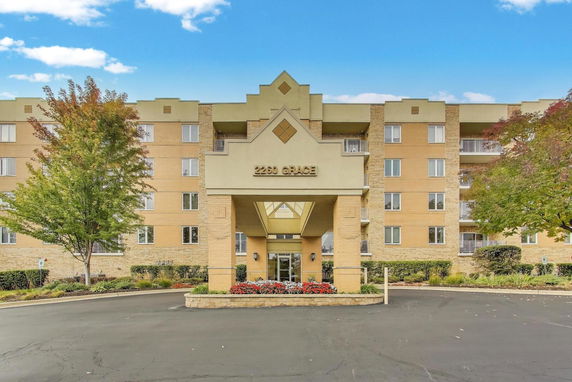 Front view of a multi-story building with a central entrance.