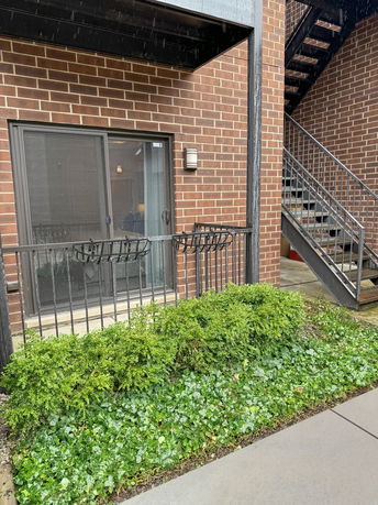 Front view of a building with brick exterior and sliding glass door.