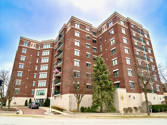 Front view of a multi-story brick apartment building.