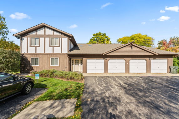 Front view of a multi-story house with a triple garage.