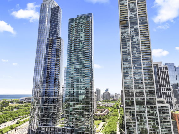 Front view of multiple tall skyscrapers in an urban setting.