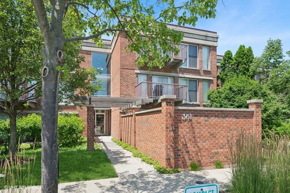 Front view of a modern two-story brick building with balconies.