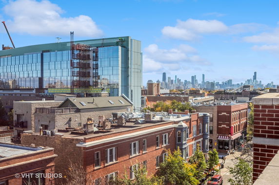 Panoramic view of a cityscape with buildings and a skyline in the background.