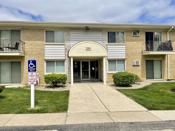 Front view of a two-story apartment building with a central entrance.
