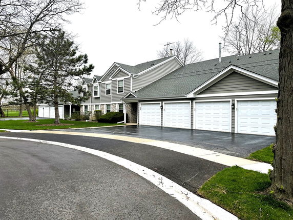 Front view of a two-story house with multiple garages.