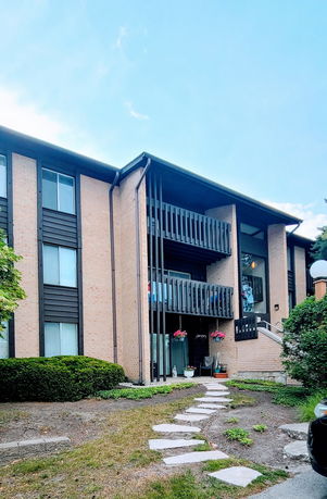 Front view of a two-story residential building with balconies.
