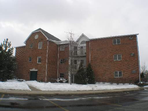 Front view of a multi-story brick apartment building.