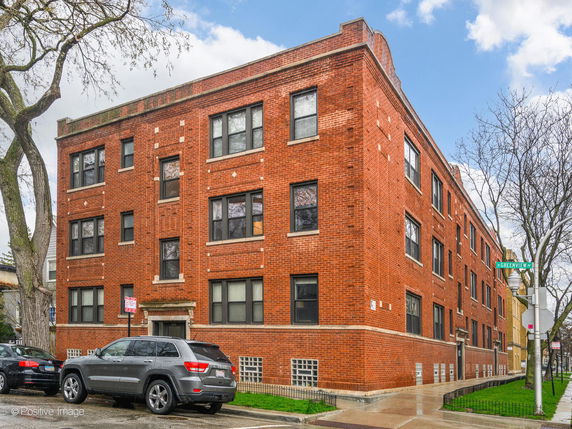 Front view of a three-story brick apartment building.