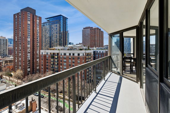 View from a balcony overlooking multiple high-rise buildings in an urban area.