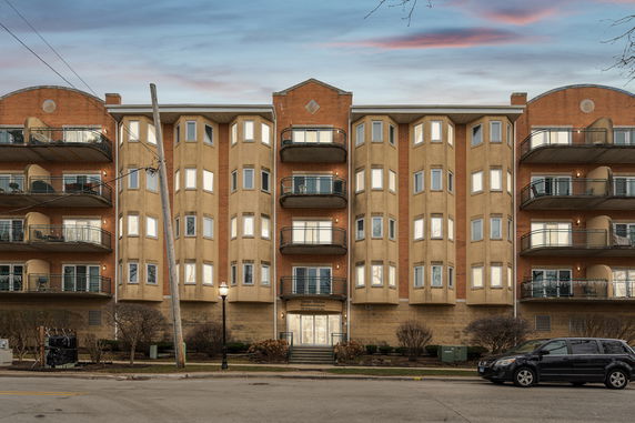 Front view of a multi-story apartment building with balconies.