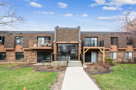 Front view of a two-story brick building with balconies.