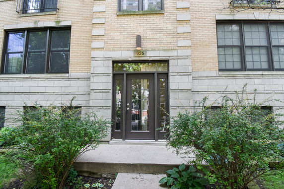 Front view of a brick apartment building entrance.