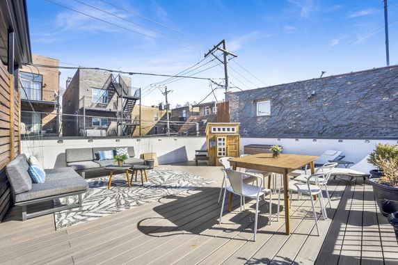 Rooftop with outdoor seating and dining area.