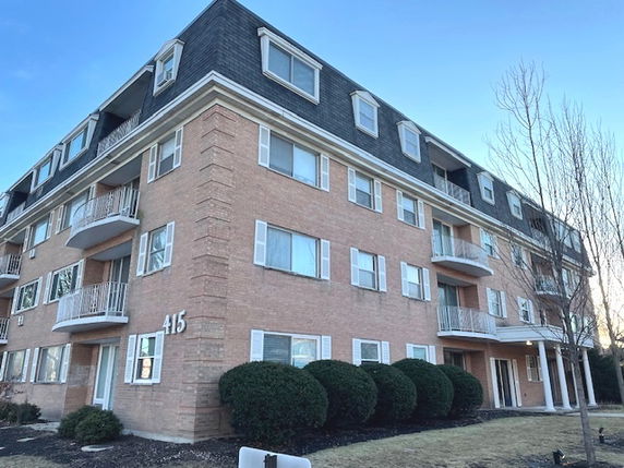 Front view of a multi-story brick building.