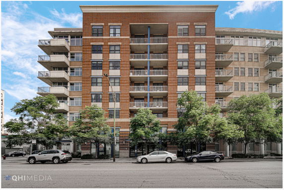 Front view of a multi-story brick building with balconies.