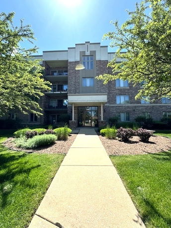 Front view of a multi-story brick building with a central entrance.
