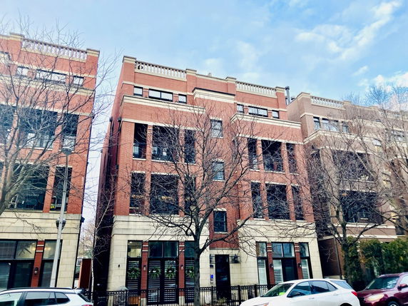 Front view of a multi-story brick apartment building.