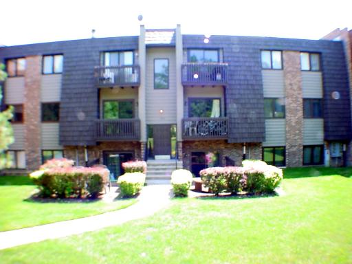 Front view of a multi-story residential building with balconies.